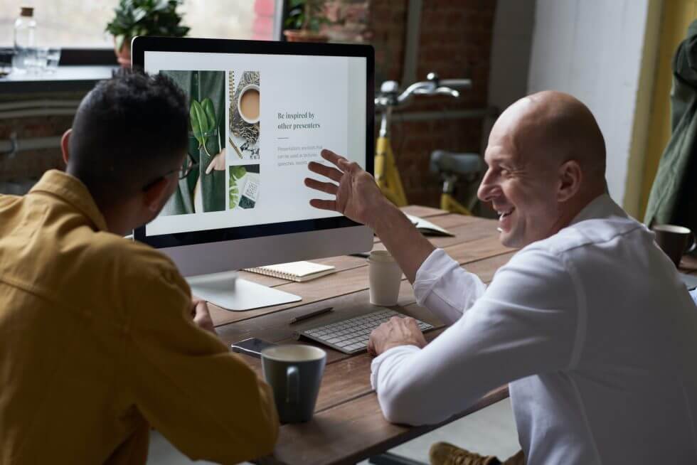 2 guys collaborating at desk