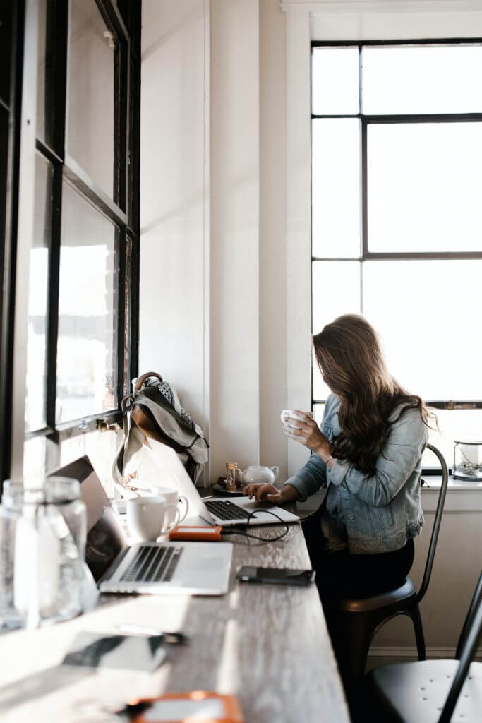 woman drinking coffee and working