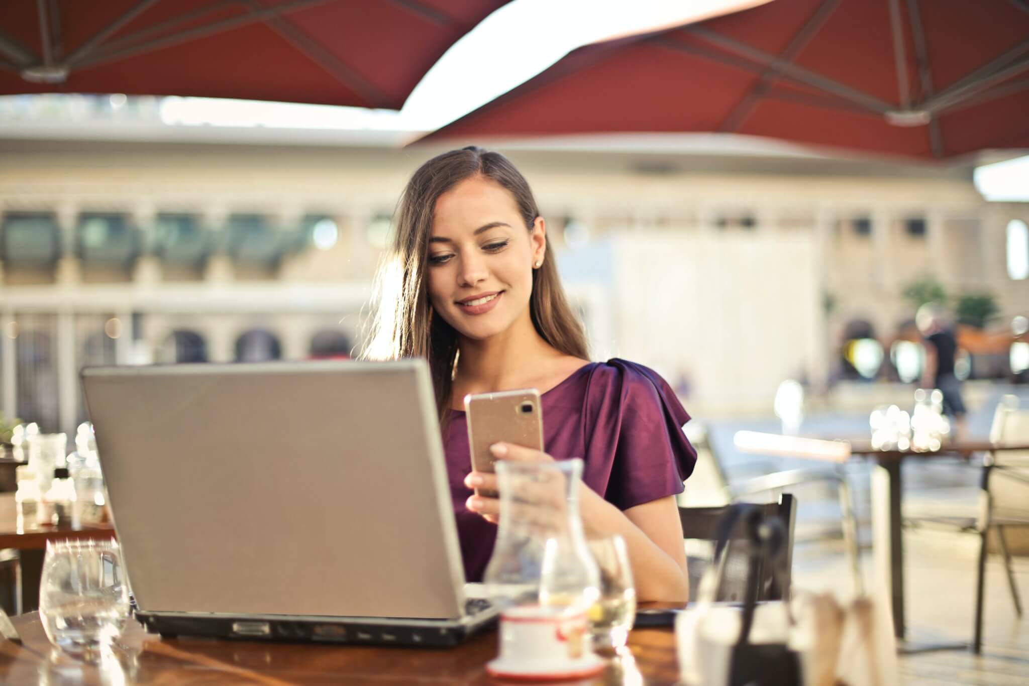 lady working at cafe looking at phone